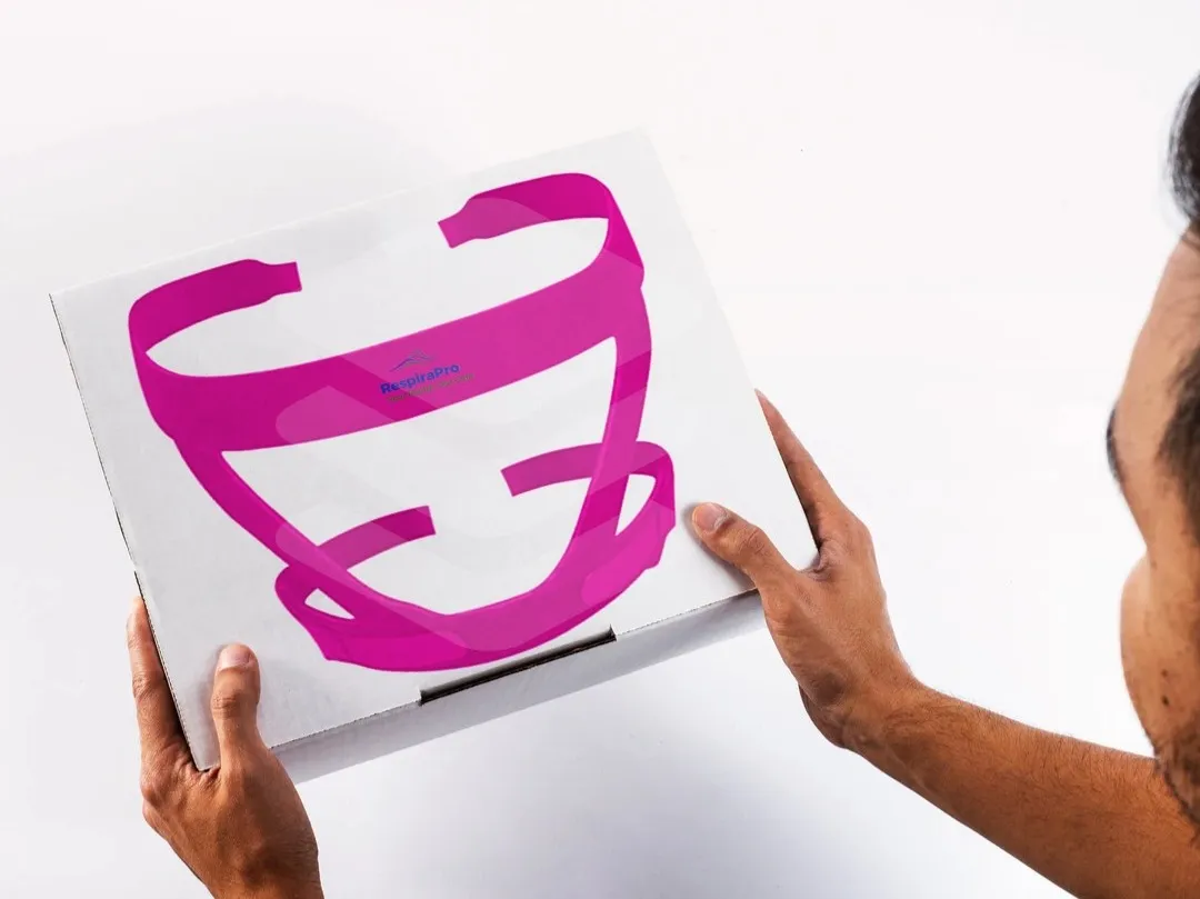 Pink RespiraPro CPAP headgear artwork displayed on a white packaging mock-up